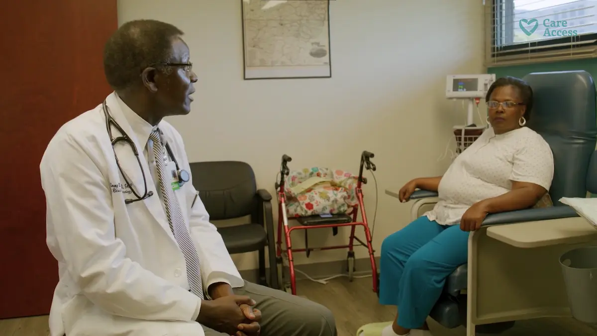 Dr. Uba speaking with patient